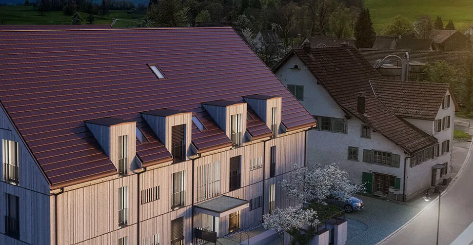 Aerial view of the completed modern residential building in Uerikon with generous balconies, showcasing Architekturfabrik21's high-quality residential architecture output.