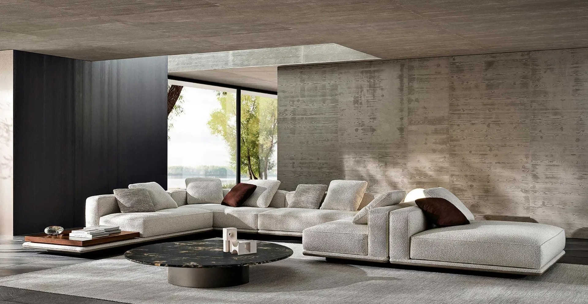 Expansive modular light-grey Minotti sofa set in a concrete-walled luxury living room.