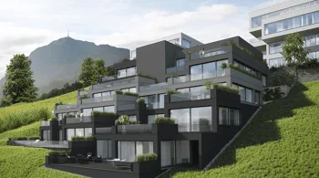 Modern dark luxury residential complex built into a green hillside with mountain backdrop.